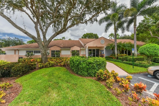 ranch-style home featuring a front yard