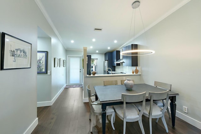 dining room with dark hardwood / wood-style floors and ornamental molding