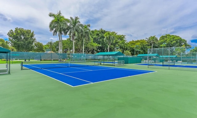 view of tennis court with basketball hoop