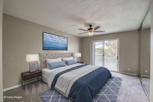 bedroom featuring access to exterior, ceiling fan, carpet, and a textured ceiling