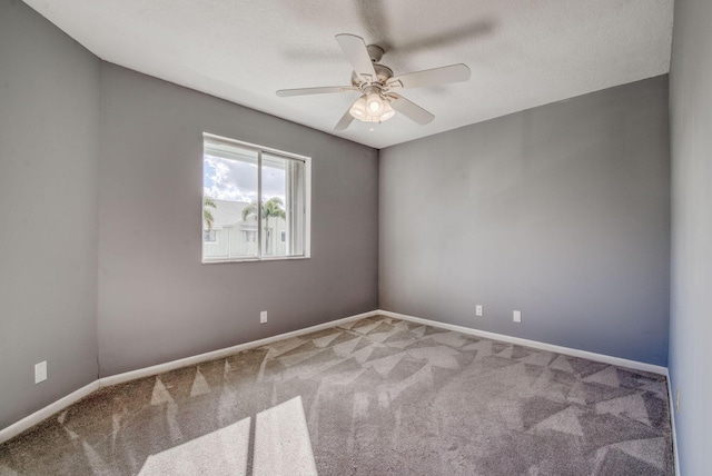 empty room with ceiling fan and carpet floors