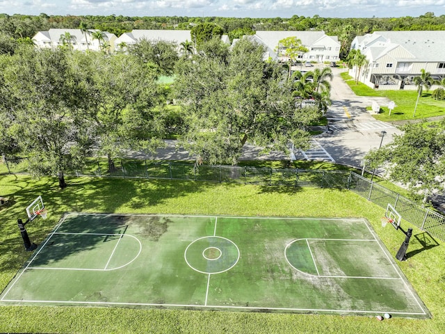 view of sport court featuring a lawn