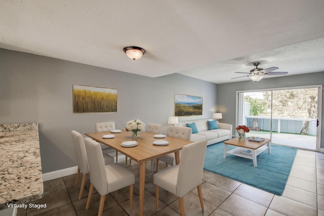 tiled dining area featuring a textured ceiling and ceiling fan