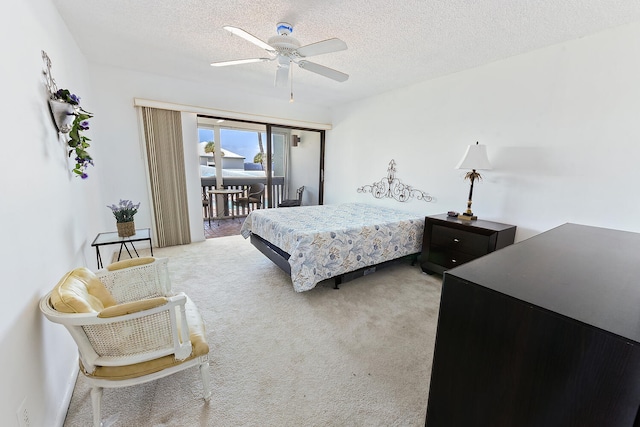 bedroom with access to exterior, a textured ceiling, carpet floors, and ceiling fan