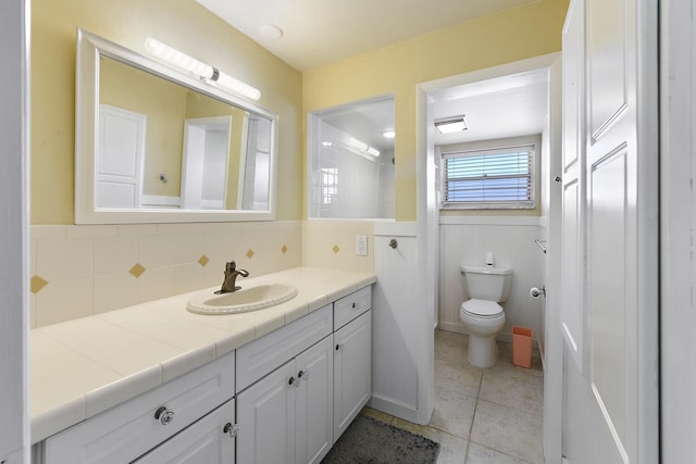 bathroom featuring tile patterned flooring, vanity, and toilet