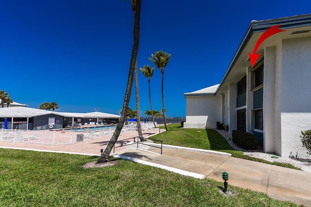 view of yard featuring a patio and a community pool