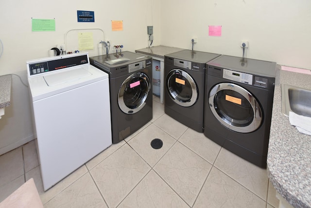 laundry room with light tile patterned floors and washing machine and clothes dryer