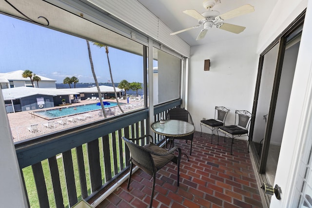 sunroom / solarium featuring ceiling fan