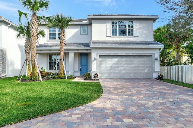 view of front facade featuring a garage and a front lawn