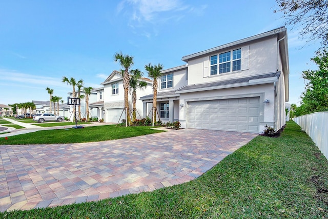 view of front of property with a garage and a front lawn