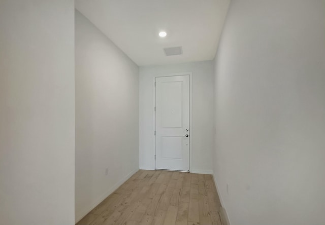 corridor with light wood-type flooring