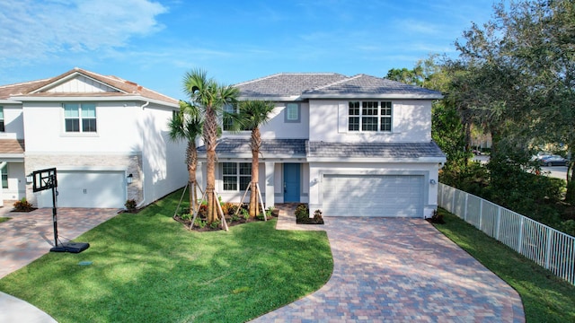 view of front of home with a front yard and a garage