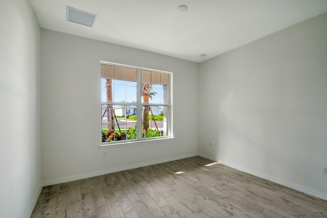 spare room with a healthy amount of sunlight and light hardwood / wood-style flooring