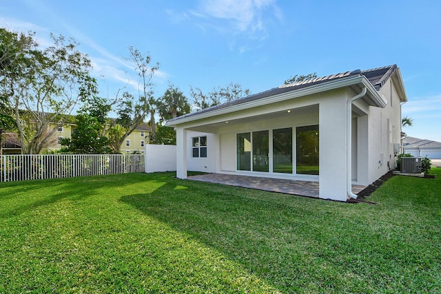 back of house with a yard, a patio, and cooling unit