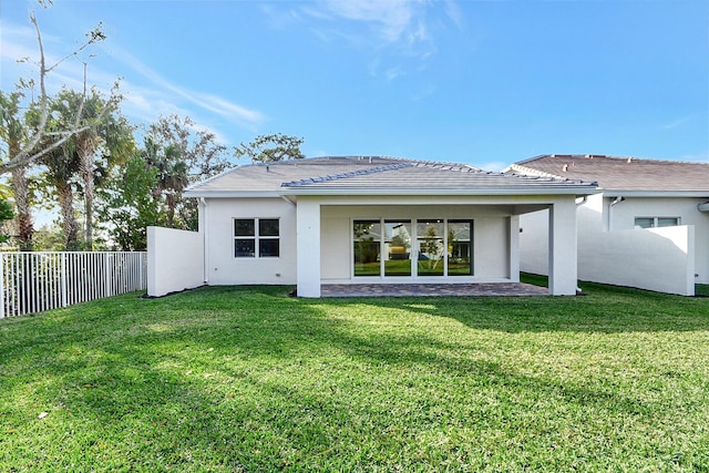 rear view of property with a lawn