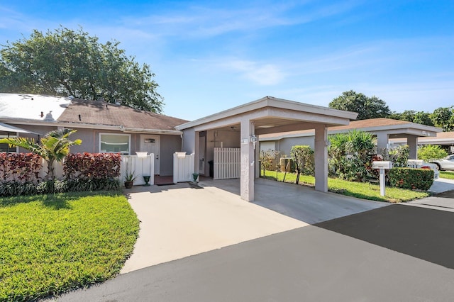 ranch-style house with a carport and a front yard