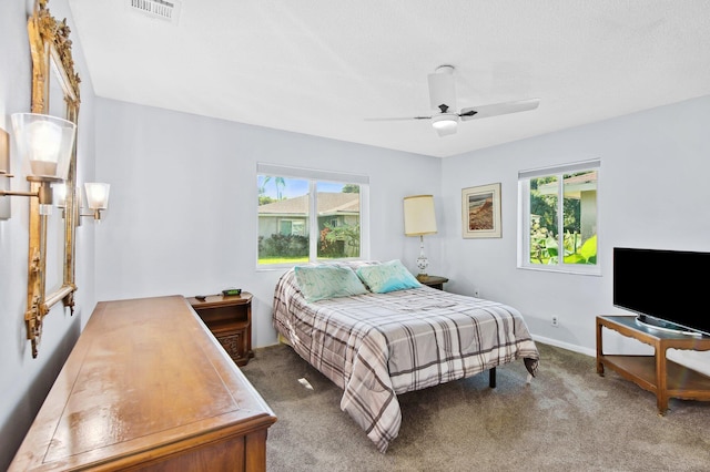 bedroom featuring carpet flooring, multiple windows, and ceiling fan