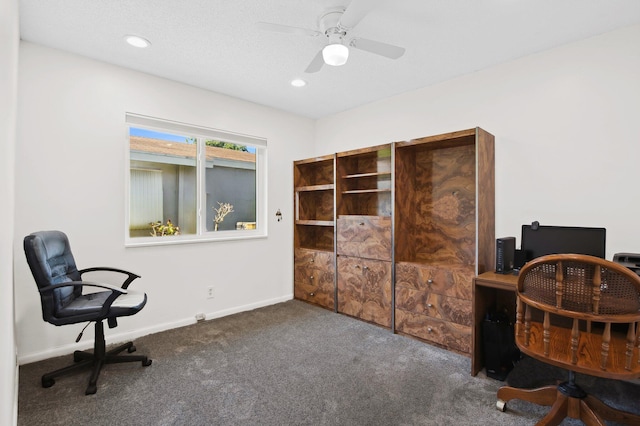 home office with dark colored carpet and ceiling fan