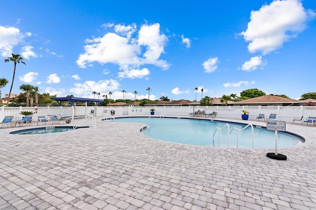 view of pool with a jacuzzi and a patio area