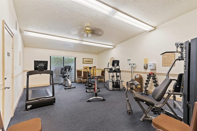 exercise room with a textured ceiling and ceiling fan