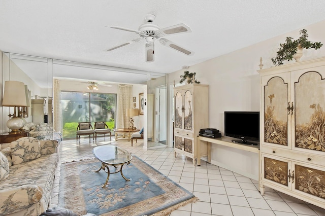 living room with a textured ceiling and light tile patterned flooring