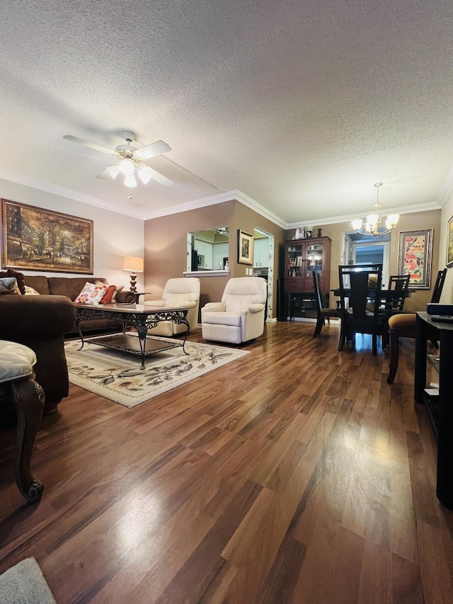 living room featuring a textured ceiling, crown molding, wood-type flooring, and ceiling fan with notable chandelier