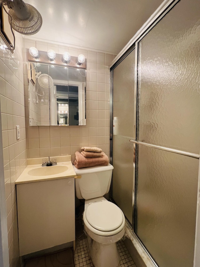 bathroom with tile patterned floors, decorative backsplash, a shower with shower door, and tile walls