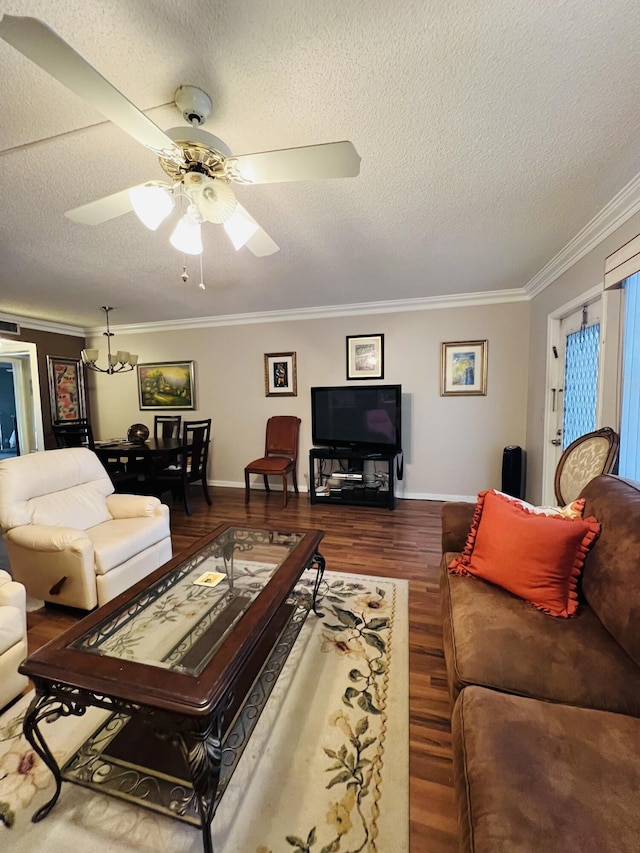 living room with hardwood / wood-style floors, ceiling fan with notable chandelier, ornamental molding, and a textured ceiling