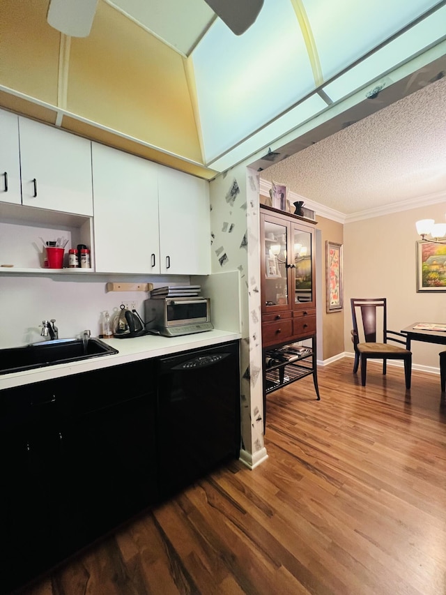 kitchen featuring dishwasher, white cabinets, sink, a notable chandelier, and wood-type flooring