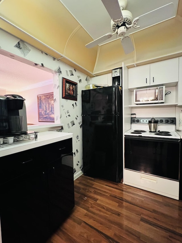 kitchen featuring black refrigerator, dark hardwood / wood-style flooring, ceiling fan, white cabinets, and white electric range