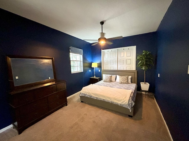 bedroom with light colored carpet and ceiling fan