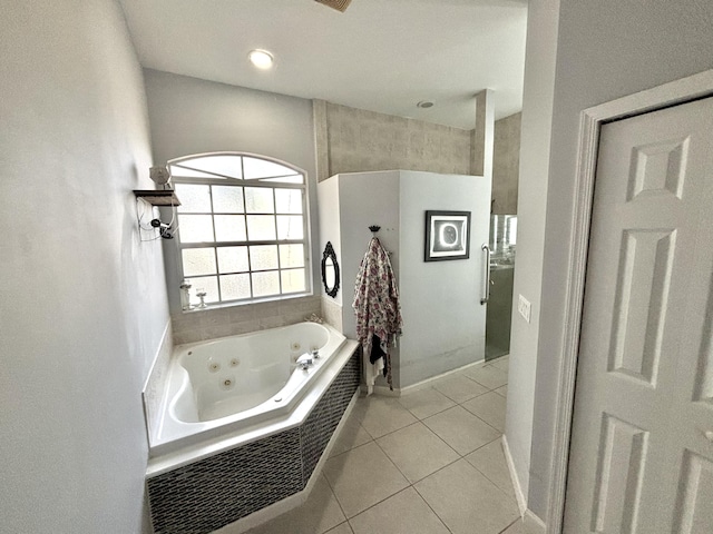 bathroom featuring tile patterned flooring and a bathtub