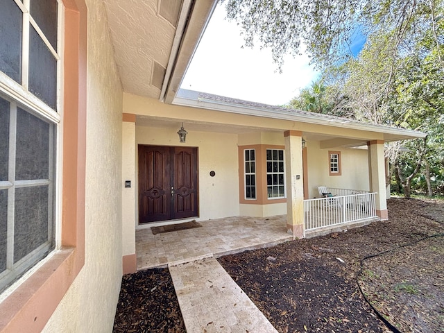 property entrance featuring covered porch