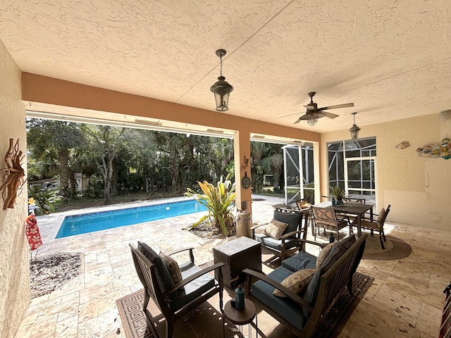 view of patio / terrace featuring glass enclosure and ceiling fan