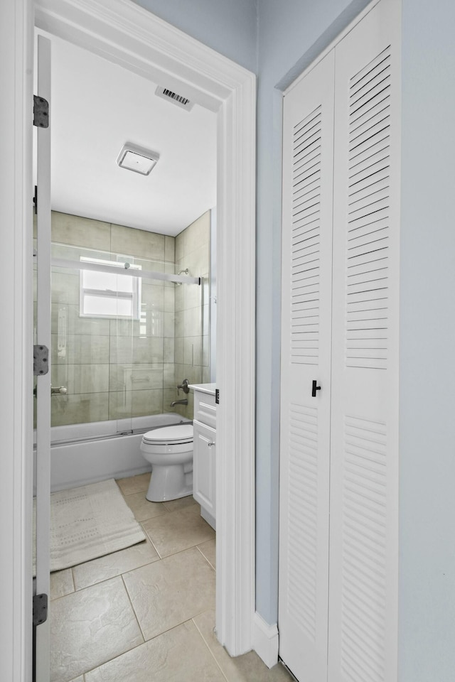 full bathroom with tile patterned floors, vanity, toilet, and shower / bath combination with glass door