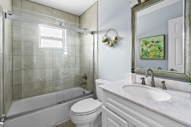 full bathroom featuring shower / bath combination with glass door, vanity, and toilet