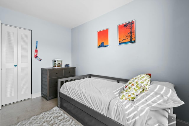 bedroom featuring a closet and light tile patterned flooring