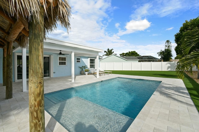 view of swimming pool featuring ceiling fan and a patio area