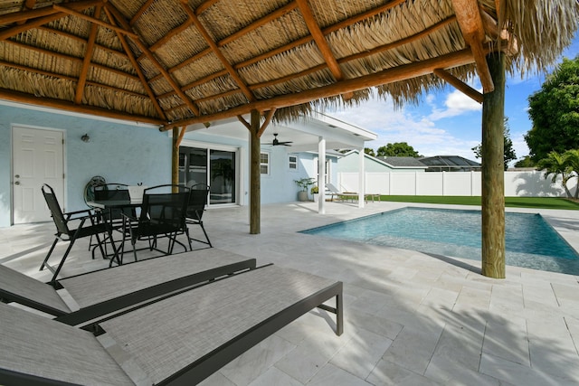 view of pool with a gazebo, ceiling fan, and a patio