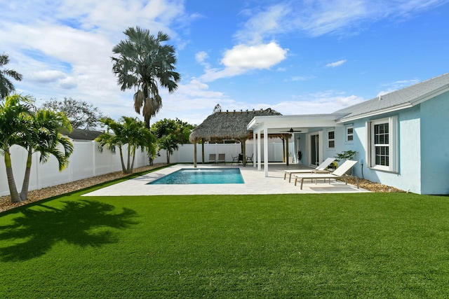 view of pool with a gazebo, ceiling fan, a yard, and a patio