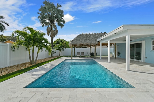 view of swimming pool with a gazebo, ceiling fan, and a patio area