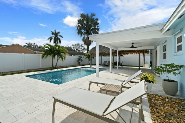 view of swimming pool featuring ceiling fan and a patio area