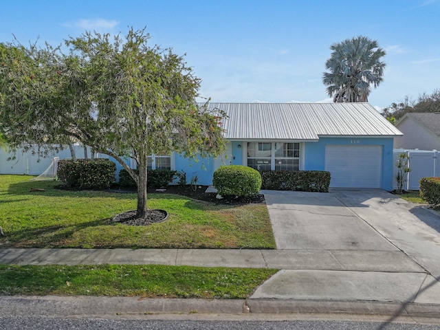 ranch-style house with a garage and a front lawn