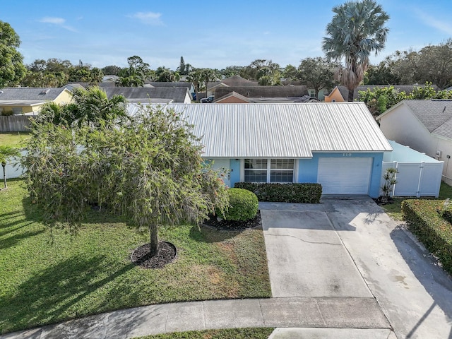 ranch-style home with a garage and a front lawn