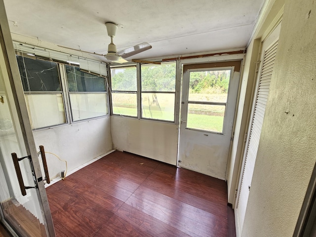 unfurnished sunroom with ceiling fan