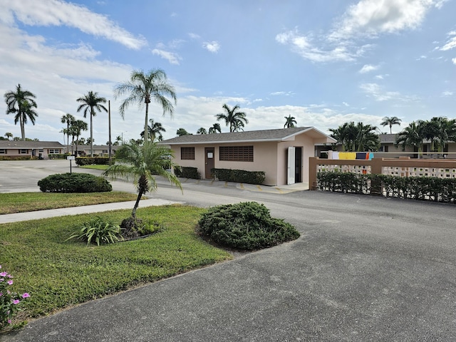 ranch-style home with a front lawn