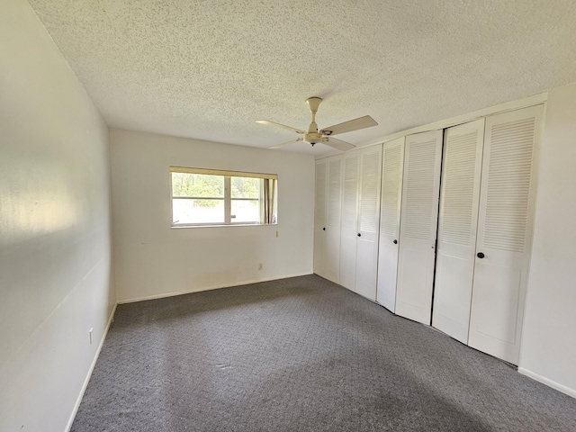 unfurnished bedroom featuring ceiling fan, carpet floors, and a textured ceiling