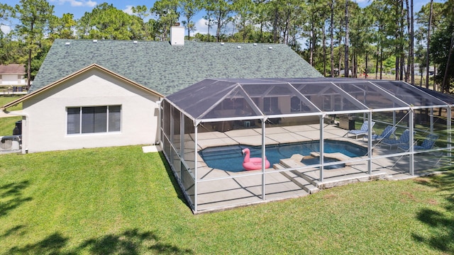 back of house with a lawn, a patio area, a swimming pool with hot tub, and glass enclosure