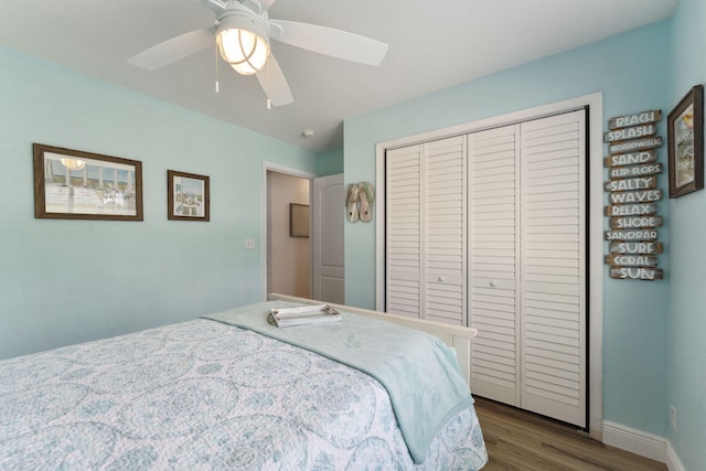 bedroom featuring ceiling fan, a closet, and hardwood / wood-style flooring