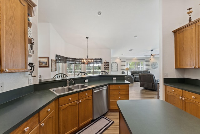 kitchen featuring sink, hanging light fixtures, light hardwood / wood-style flooring, stainless steel dishwasher, and ceiling fan with notable chandelier